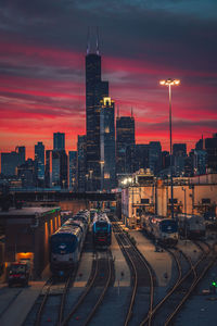 High angle view of illuminated buildings against sky at sunset