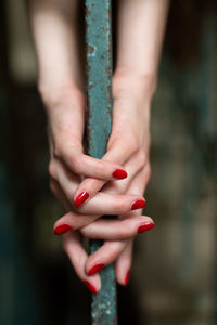 Cropped hands of woman holding metal