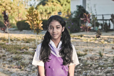 Portrait of smiling girl standing outdoors