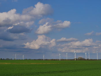 Windmill on field against sky