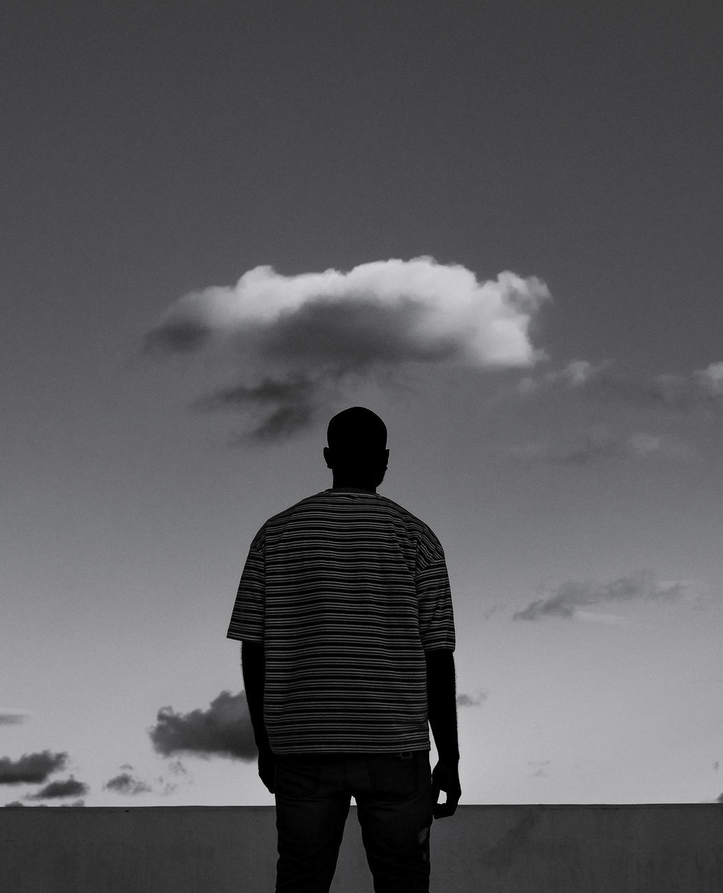 cloud - sky, sky, rear view, one person, men, real people, standing, three quarter length, lifestyles, nature, casual clothing, leisure activity, day, striped, outdoors, architecture, silhouette, built structure, males