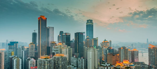 Illuminated cityscape against sky at night