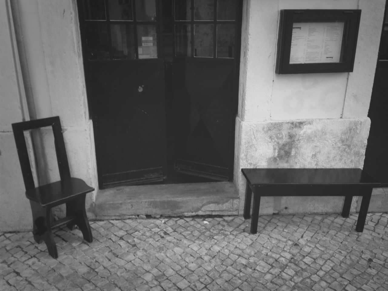 chair, empty, absence, architecture, built structure, seat, building exterior, furniture, window, bench, house, table, flooring, wall, door, no people, day, wall - building feature, tiled floor, cobblestone