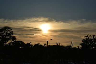 Silhouette trees against sky during sunset