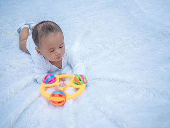 High angle view of baby playing with toy