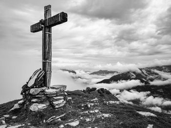 Cross on field against sky