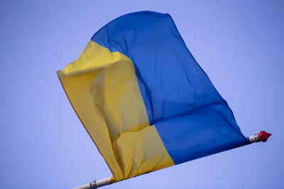 Low angle view of flag against clear sky