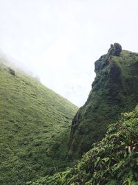 Low angle view of man on cliff against sky