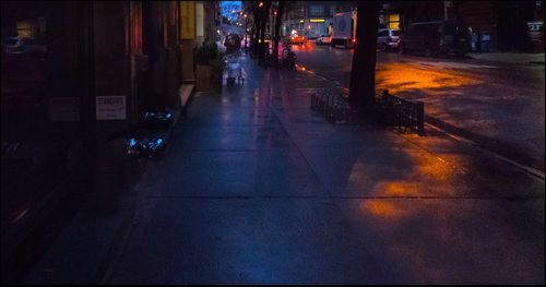 Narrow road along buildings at night