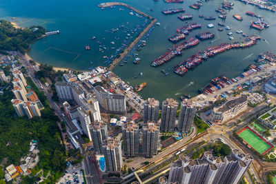 High angle view of city by sea and buildings