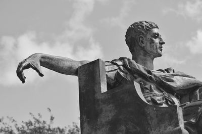 Low angle view of statue against cloudy sky