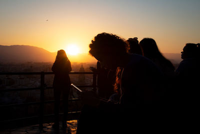 Silhouette people at sunset