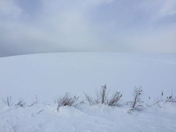 Scenic view of snow covered land against sky