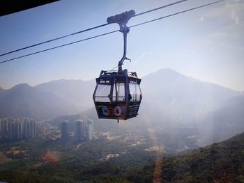 Overhead cable cars against mountain range