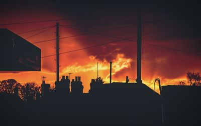 Silhouette buildings against sky during sunset
