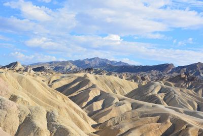 Scenic view of mountains against cloudy sky