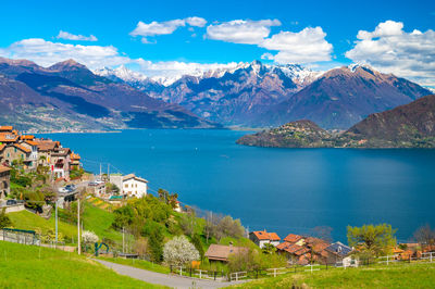 View of lake como, looking north, from musso, with alps, villages and the mountains of valtellina.