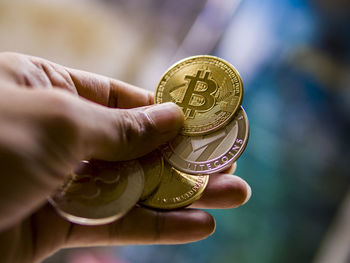 Close-up of a hand holding coin