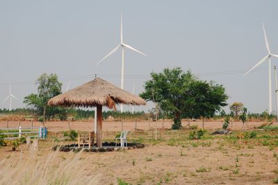 Traditional windmill on field against clear sky