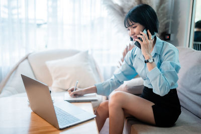 Young woman using laptop at office