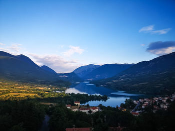 Scenic view of lake and mountains against sky