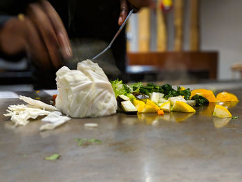 Person preparing food on table in restaurant