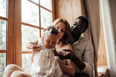 Midsection of mother and daughter at home