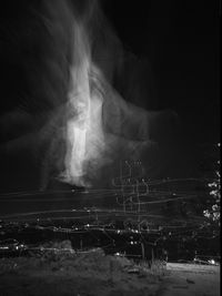 High angle view of illuminated man and city at night