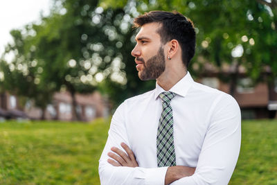 Portrait of young man standing in park