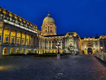 View of illuminated building in city at night