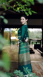 Portrait of smiling young woman standing in city