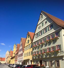 Low angle view of buildings against clear blue sky