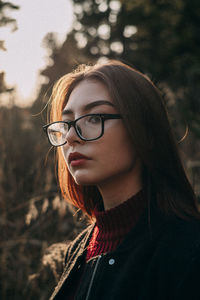 Close-up portrait of young woman looking away