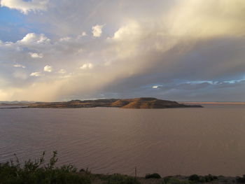 Scenic view of sea against cloudy sky