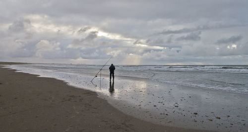 Man on beach against sky