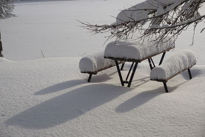 Empty chairs on beach during winter