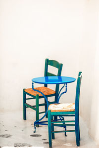 Chairs and table against wall