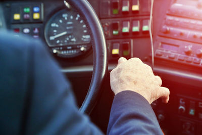 Cropped hand of man driving vehicle
