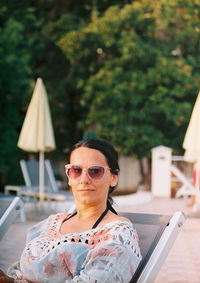 Portrait of young woman using mobile phone outdoors