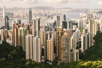 Aerial view of buildings in city against sky