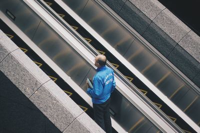 High angle view of man on escalator