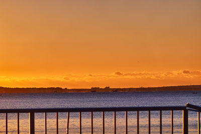 Scenic view of sea against orange sky