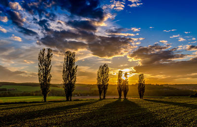 Scenic view of field against cloudy sky