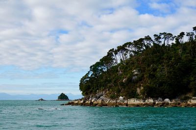 Scenic view of sea and mountains against sky