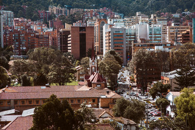 High angle view of trees and buildings in city