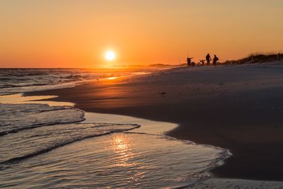 Scenic view of beach against sky during sunset