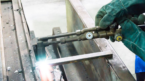 Close-up of worker working on bridge