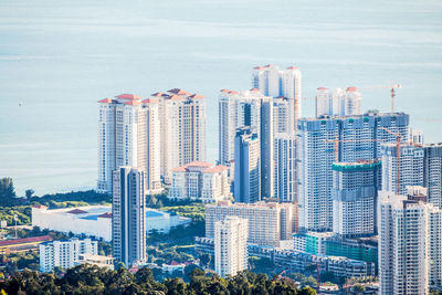 High angle view of modern buildings in city against sky