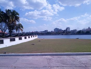 Scenic view of sea by city against sky