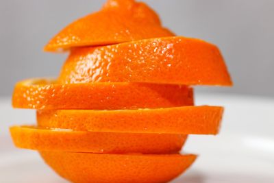 Close-up of orange fruit against white background